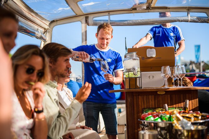 Amsterdam: Canal Booze Cruise with Unlimited Drinks Option - Getting On Board: Mobile Ticket, Central Meeting Points, Rain-Ready Boat