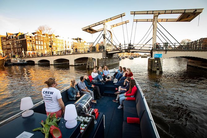 Amsterdam Canal Cruise With Live Guide and Unlimited Drinks - What to notice on the water: bridges, towers, and the small surprises