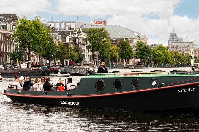 Amsterdam Classic Canal Cruise on a Historic Tugboat - Maritime museum stop: look for the VOC ship replica moored outside