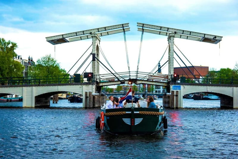 Amsterdam Evening (Sunset) Canal Cruise w/ optional drinks - The Guide Experience: Live Storytelling in English Plus an 8-Language Booklet