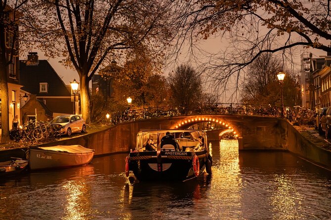 Amsterdam Evening (Sunset) Canal Cruise with optional drinks - Open-boat comfort on summer nights: hood, ponchos, and sunscreen