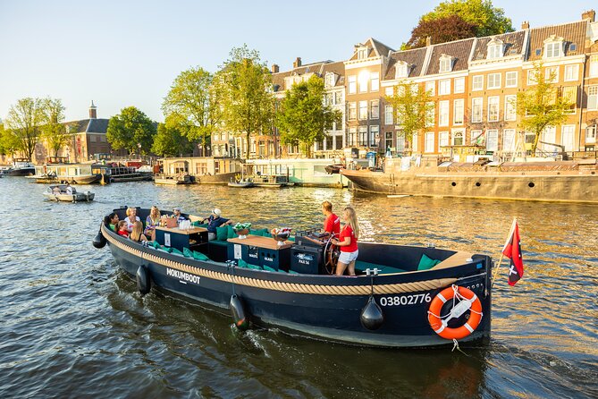 Amsterdam: Guided Open Boat Canal Cruise Unlimited Drinks Option - Science stop at NEMO, then maritime history in the former navy storage