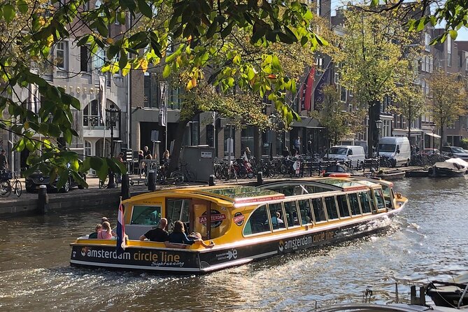 Amsterdam: Historic City Sightseeing Canal Cruise - Canal houses and a bridge with milk-market history