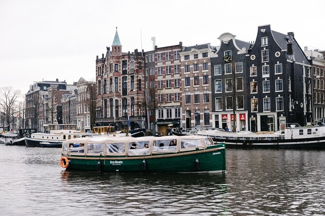 Amsterdam Newest Canal Cruise with local guide and small group - Open-boat comfort: ponchos, umbrellas, and staying warm or cool