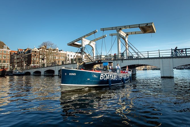 Amsterdam Open Boat Cruise with Live Guide and Two Drinks - The boat setup: open-air electric, then heated seats in winter