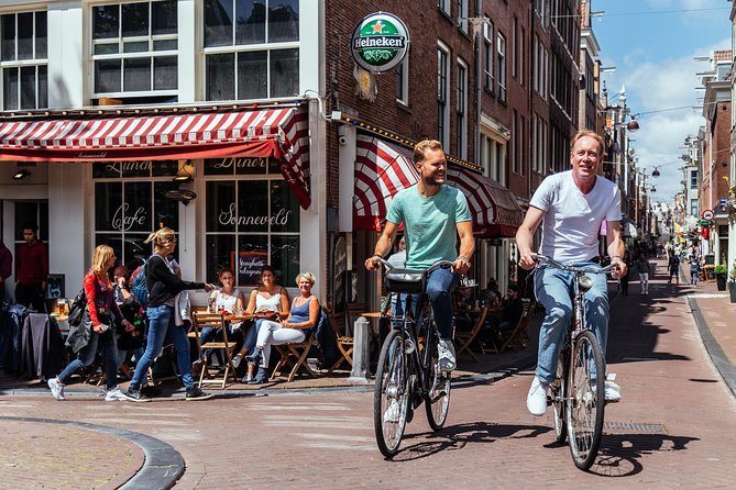 Amsterdam PRIVATE Bike Tour With Locals: Bike & Local Snack Included - Magere Brug (Skinny Bridge): The Stop Built for Views