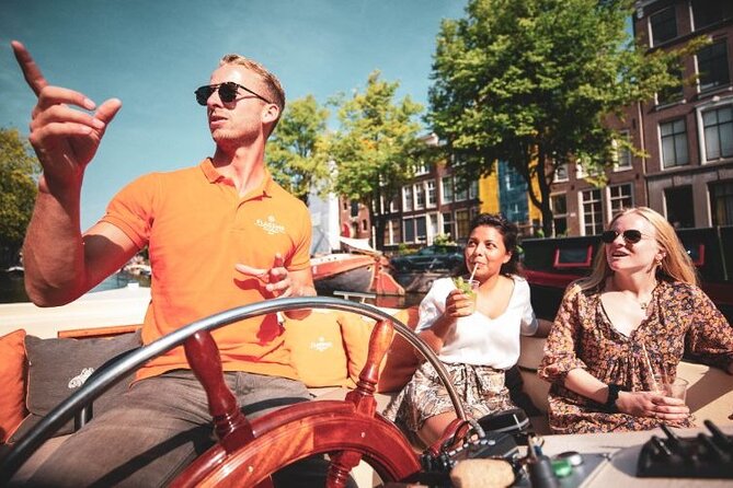 Amsterdam Private Boat Tour with Unlimited Drinks - Bridges, flower power, and the green ship-like science stop