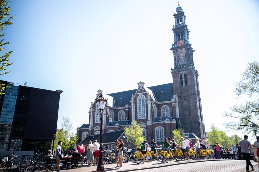 Amsterdam: Relaxed City Highlights Guided Bike Tour - Leidseplein: entertainment square with stories attached