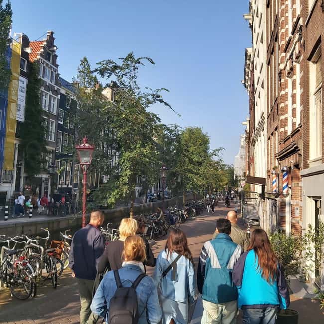 Amsterdam: Spanish Tour Unmasking the Redlight District - Nieuwmarkt Square and De Waag: where trade meets civic power