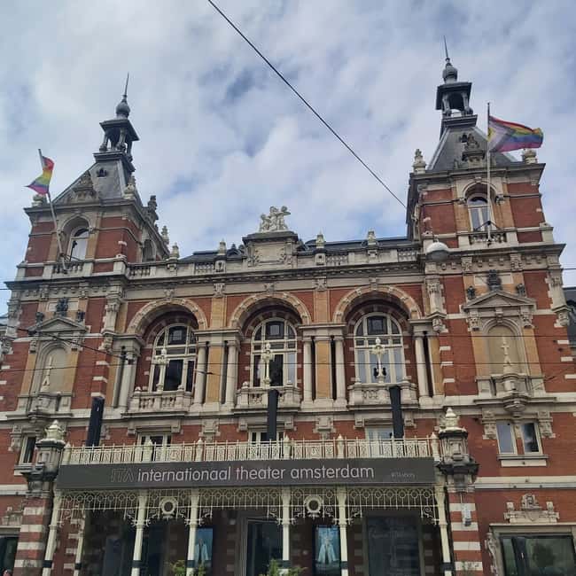 Amsterdam: Spanish Tour Unmasking the Redlight District - From St. Nicholas Basilica to Zeedijk: the port-to-people story