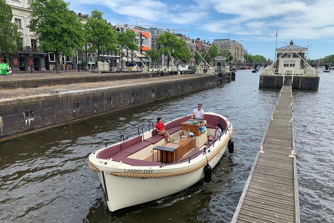 Guided Amsterdam Canal Cruise – Snacks & Drinks on board(1 Hour) - The big sights: ship-shaped buildings, bridges, and merchant-canal drama