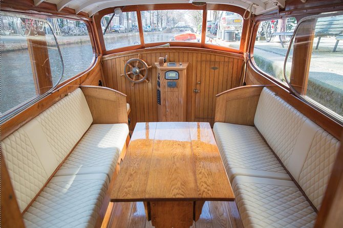 Private Champagne Canal Cruise in Amsterdam - The boat and bar setup: classic comfort with a semi-open feel